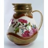 Doulton Lambeth Jug: Decorated and gilded with flowers, height 19cm.