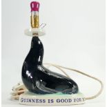 Carltonware Advertising Guinness lamp base: As a seal on a base.