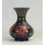 William Moorcroft vase decorated in the Pomegranate design on green ground: Height 15.5cm, c1930s.