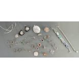A collection of silver pendants, lockets, bracelets & charms: Some set with semi precious stones,