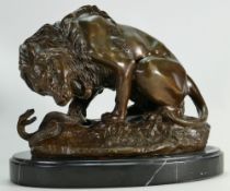 Reproduction Bronze figure of a Lion & Snake: Mounted on black marble base, height 22cm.