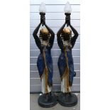 A good pair of resin life size decorative figural lamps of Egyptian queens holding glass lamps:
