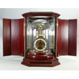 Franz Hermle & John quality Table clock: A Richard Hermle design under glass dome in Mahogany case.