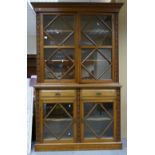 Early 20th century Golden oak glazed two door Bookcase: With carved decoration and four glazed