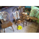 A farmhouse oak armchair: plus 3 similar dining chairs (4)
