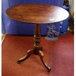 A late Georgian tilt top occasional table: 60cm diameter (max), height 65cm.