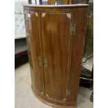 A mahogany corner cupboard.