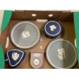 A collection of Wedgwood jasper ware: to include grey wall plates, lilac small mantle clock and