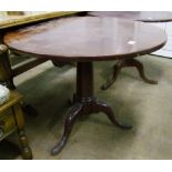 A mahogany pedestal tripod table: