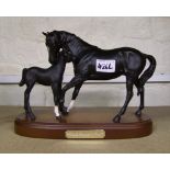 Royal Doulton black beauty and foal on wooden plinth.