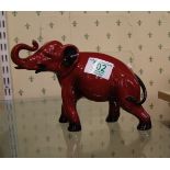 Royal Doulton Flambe model of a Elephant: Elephant with trunk in salute, height 14cm.