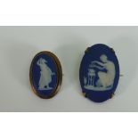 Wedgwood dark blue jasper ware oval brooches: set with metal mounts.