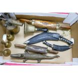 A mixed collection of items to include: Kukri Knives, similar items , Brass School bell,