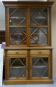Early 20th century Golden oak glazed two door Bookcase: With carved decoration and four glazed