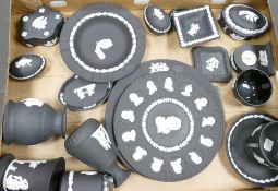 A collection of Wedgwood black basalt jasper ware items to include: plates, vases,