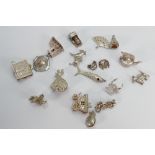 18 silver coloured charms: One noted with hallmarks,