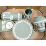 A collection of Wedgwood sage green items to include: jugs, small tazza, mantle clock,