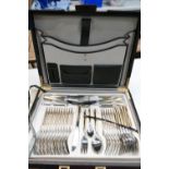 A canteen of stainless steel cutlery in a leather carry case