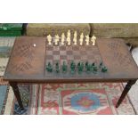 Carved wooden / metal chess table on fluted legs: together with chess pieces (1 damaged)