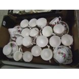 A large collection of floral decorated cups and saucers: