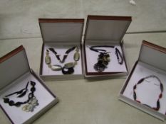 A quantity of Chavin carved horn necklaces: boxed (4).