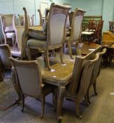 A modern carved extending dining table: with glass top, six arm chairs and two carvers. 150cm long x