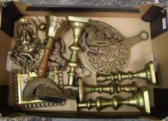 A collection of brass ware to include: candlesticks, trivet stands, school bell, horse brasses etc