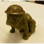 Seated bulldog with tin hat: in green glaze. Similar to the Royal Doulton model height 16cm