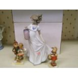 A Nao lady figure of a girl holding a vase: together with two Geobel figures of a girl with