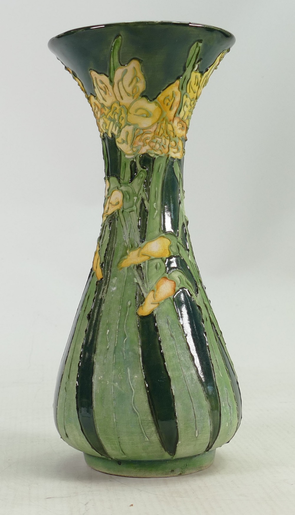 Lise B Moorcroft part glazed vase: In green with daffodils. Chip to rim. 21cm high. 2009.