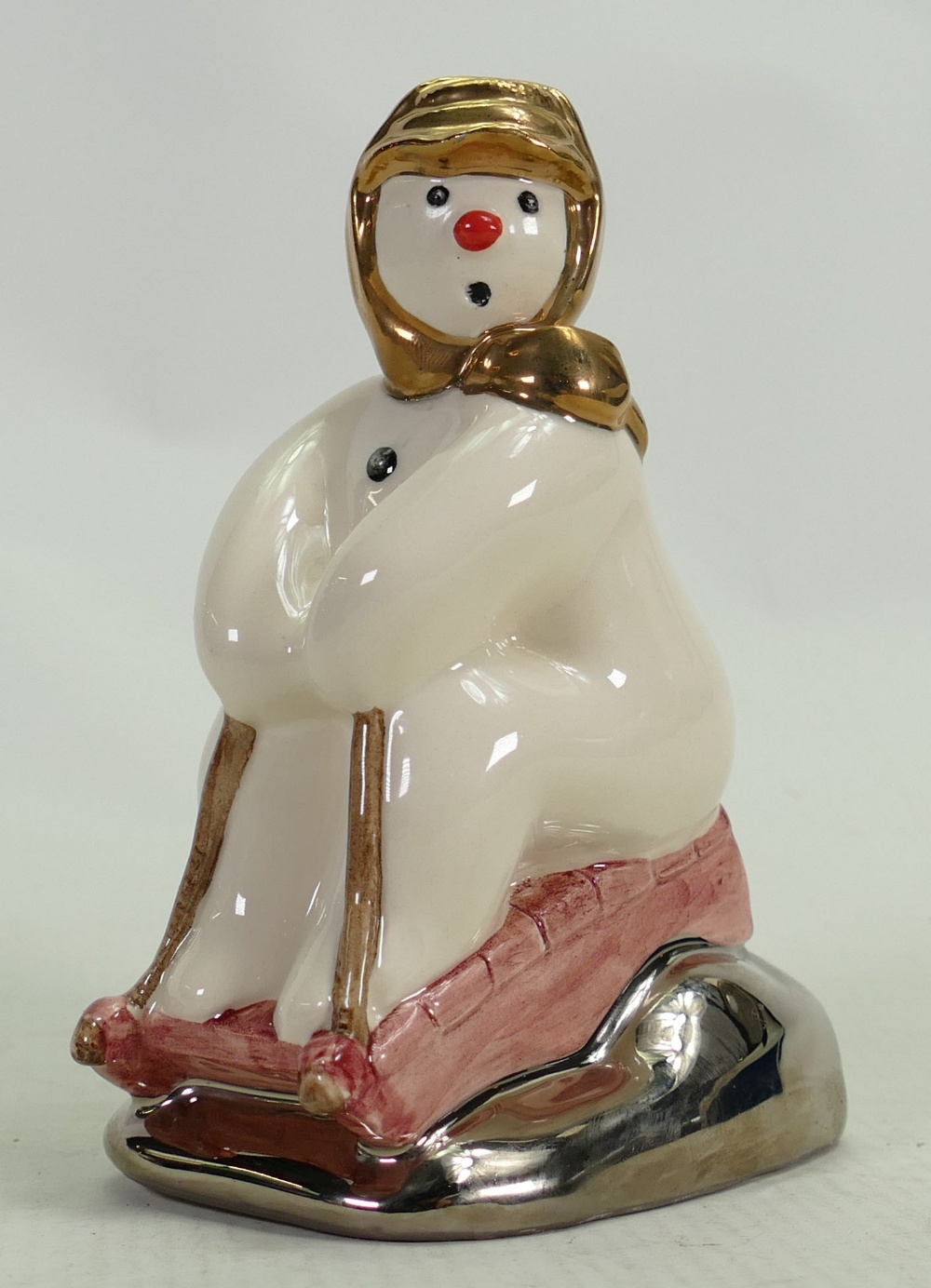 Royal Doulton Snowman prototype figure Tobogganing: In a different colourway with silver & gold
