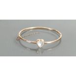 Moonstone & yellow coloured metal bangle: Heart shaped gemstone 9mm wide. Gross weight 5.6g.
