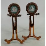 Pair of copper fire side stands both with Wedgwood green medallions: Height 35cm.