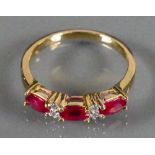 18ct gold ladies ring set with 3 Rubies and Diamond: Size N, 3.1g.