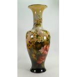 Doulton Lambeth large Faience vase: Hand painted with flowers, berries and leaves, height 62.5cm.