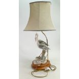 Capo di Monte bisque porcelain table lamp modelled as two herons: On an oval turned beechwood base,