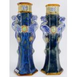 Pair of Doulton Lambeth vases: The two handles as Griffins, height 28cm.