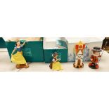 A collection of boxed Walt Disney figures: It's a small world England, Snow White, Snow White larger