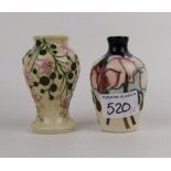 A Moorcroft Wild Cyclamen pattern vase: together with a pink floral pattern vase, both boxed,