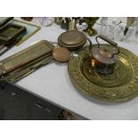 A collection of brass and copper items: to include a large circular wall plaque, peacock decorated