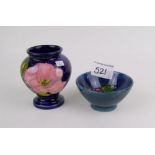 A Moorcroft magnolia pattern vase (glaze fault): together with small pansy pattern bowl, both boxed,