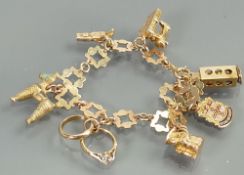 9ct gold charm bracelet: Seven charms (1 not gold), gross weight 21.