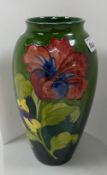 Moorcroft large Hibiscus vase: On a green to blue ground. Walter Moorcroft in green to base.