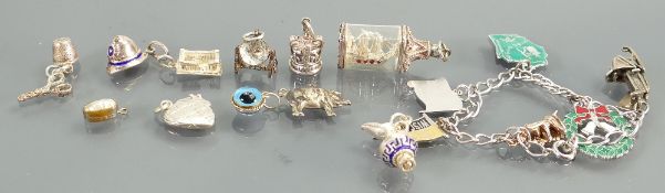Small silver charm bracelet & six charms;