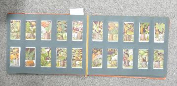 Album containing 200 about WWII period cigarette cards: Includes trains, boats, flowers,