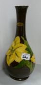 Moorcroft Bermuda lily bottle vase: On brown ground.