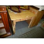 Old stripped pine kitchen table having one drawer.
