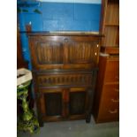 Reproduction oak cocktail cabinet having rising top.