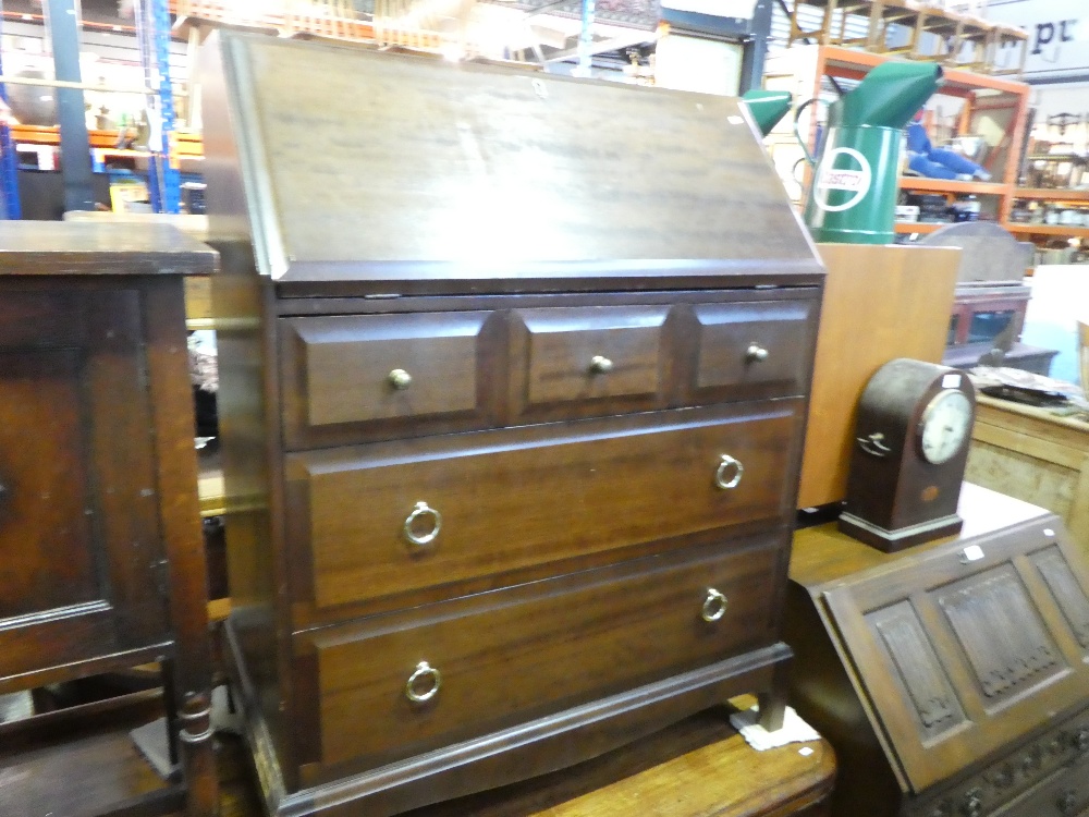 A stag writing bureau with 3 short over 2 long drawers together with an old charm example