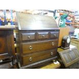 A stag writing bureau with 3 short over 2 long drawers together with an old charm example